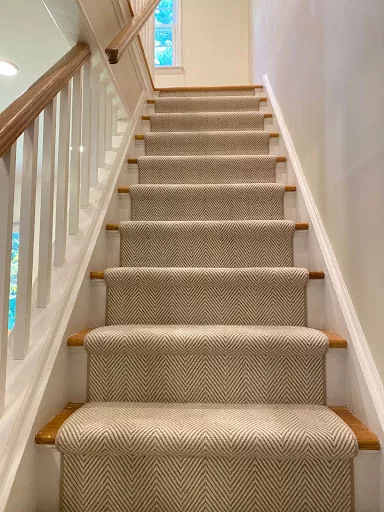 Cream and white carpet with a cheveron style and a narrow cream binding fabricated and installed as a stair runner.