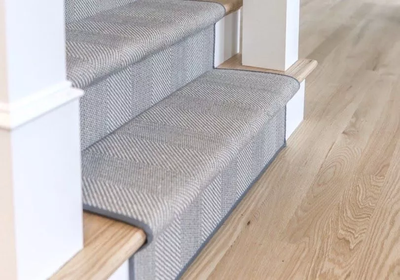 Installed grey stair runner carpet herringbone style with narrow binding by The Carpet Workroom.