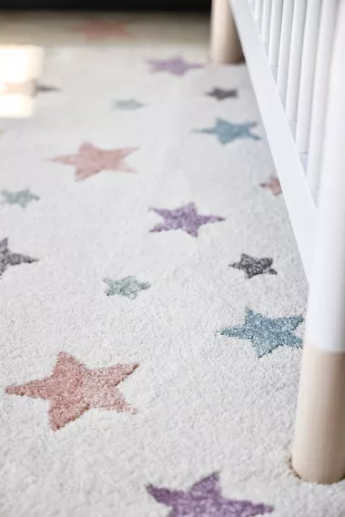 Room with wall to wall carpet, designed with stars of different colors.