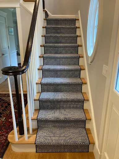 Black and white, geometric patterned stair runner with narrow black binding is a charming addition to any stair case.