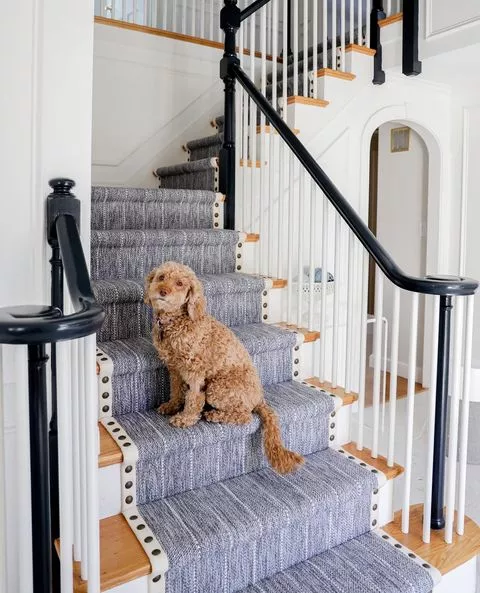 This is a navy blue and white striped carpet that is fabricated and installed as a stair runner.