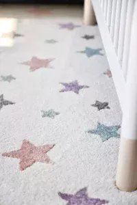 Room with wall to wall carpet, designed with stars of different colors.