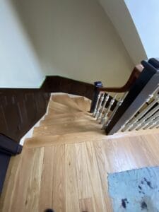 wood staircase before custom rainbow stair runner