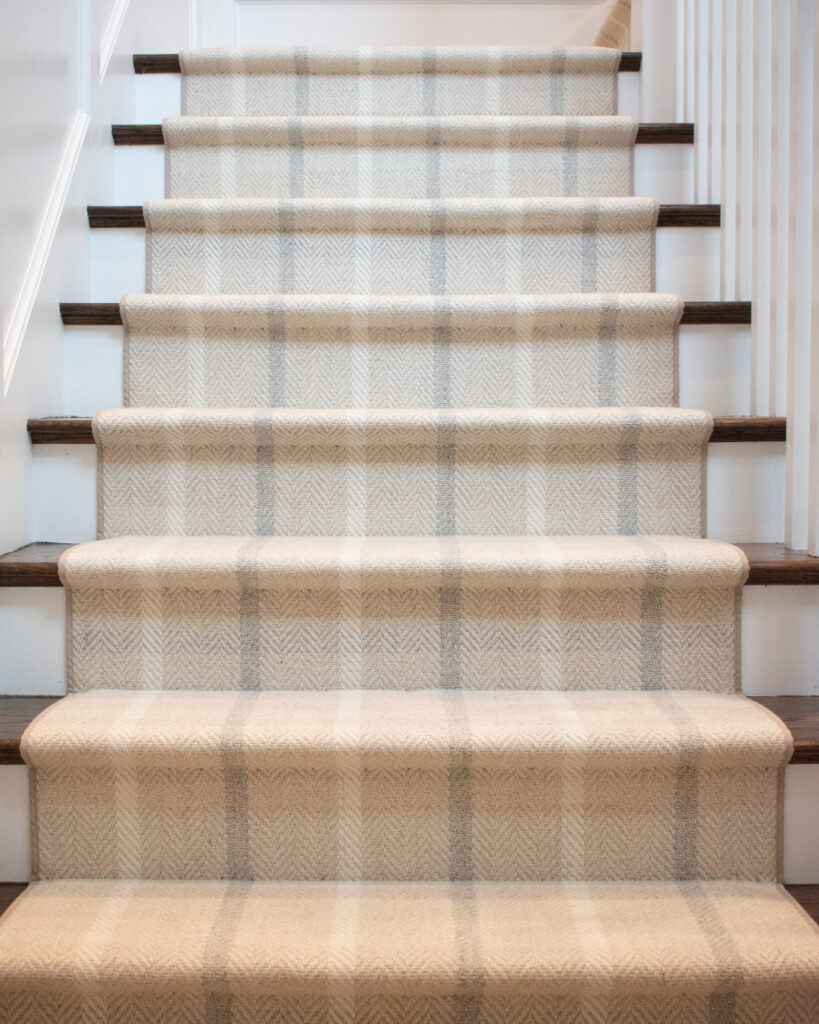 Plaid patterned wool stair runner installed hollywood style 