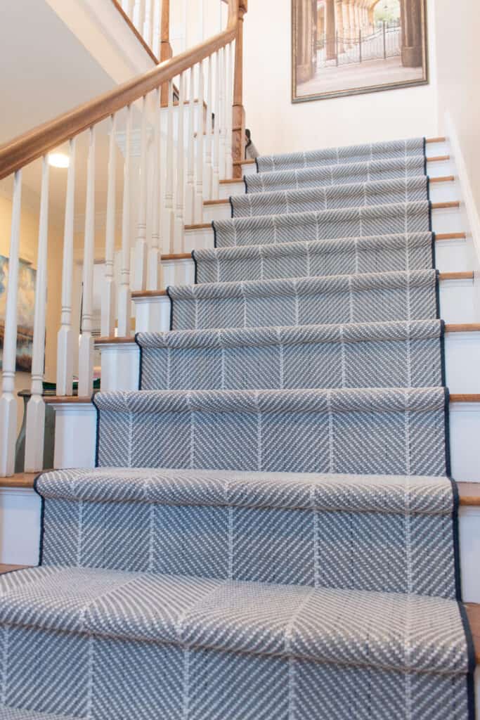 Blue stair runner with white striped installed hollywood style 