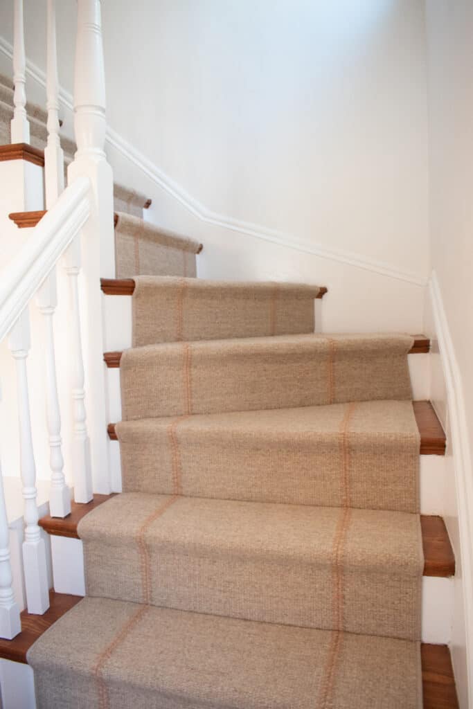 Tan wool stair runner with a baseball stitch installed hollywood style.