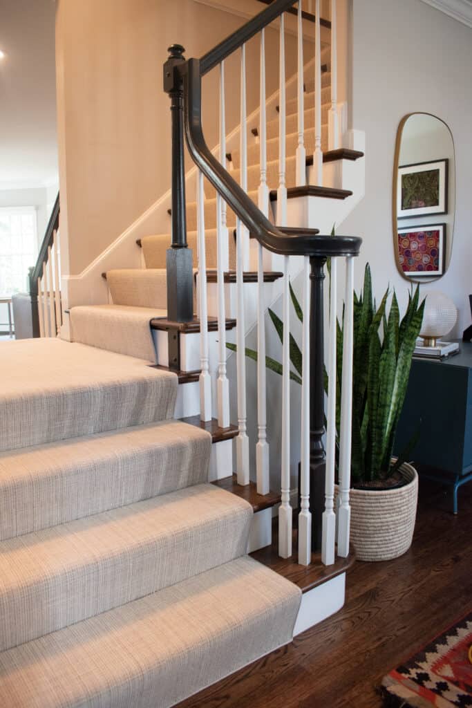 Neutral color Stair runner with a narrow cotton binding and installed using the 'waterfall' method.