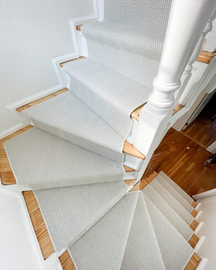 Silver stair runner on a stair set with pie turns.
