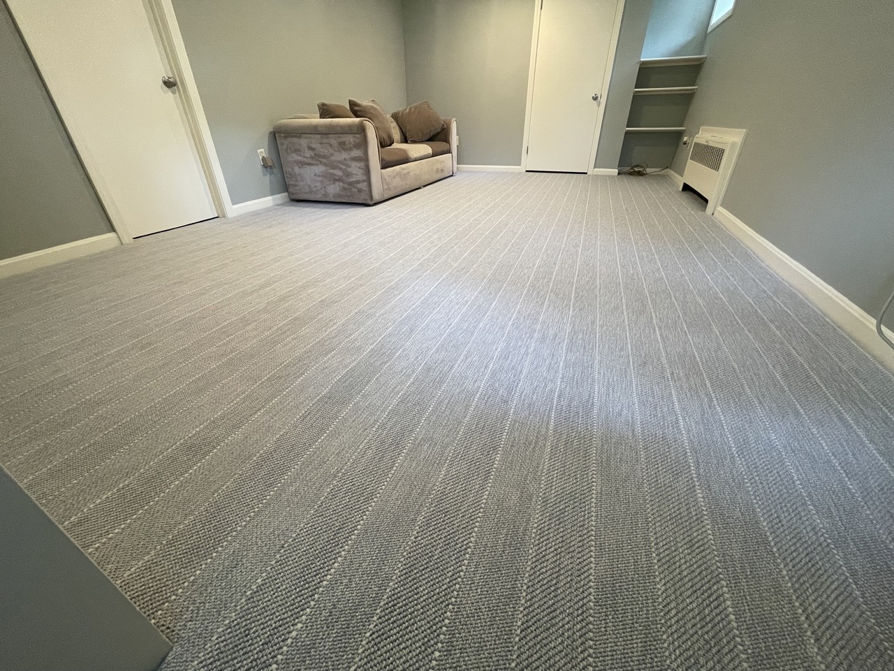 A room receives a flooring makeover with its new wall-to-wall carpet flooring.