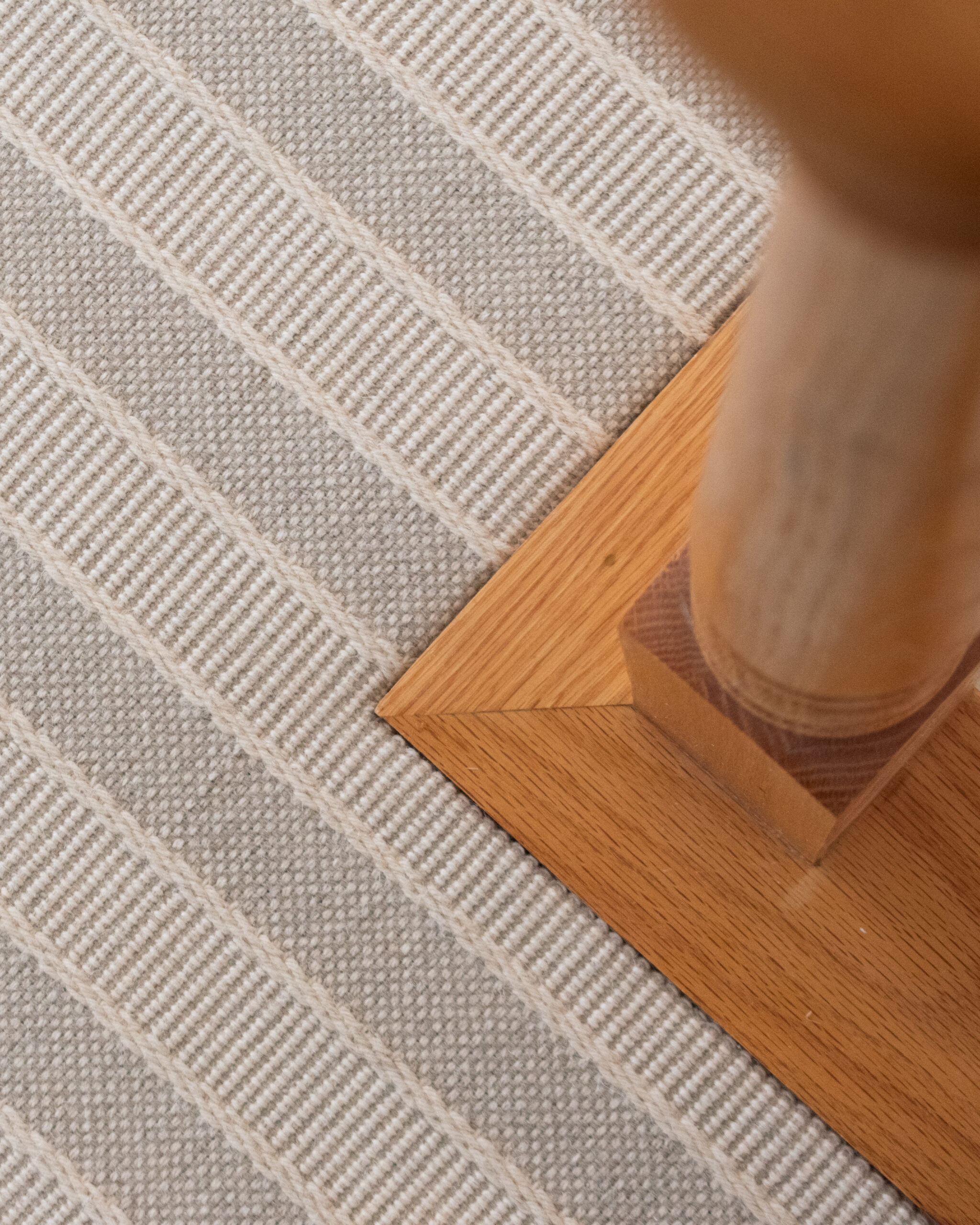 carpet meets the edge of hardwood flooring next to stairs