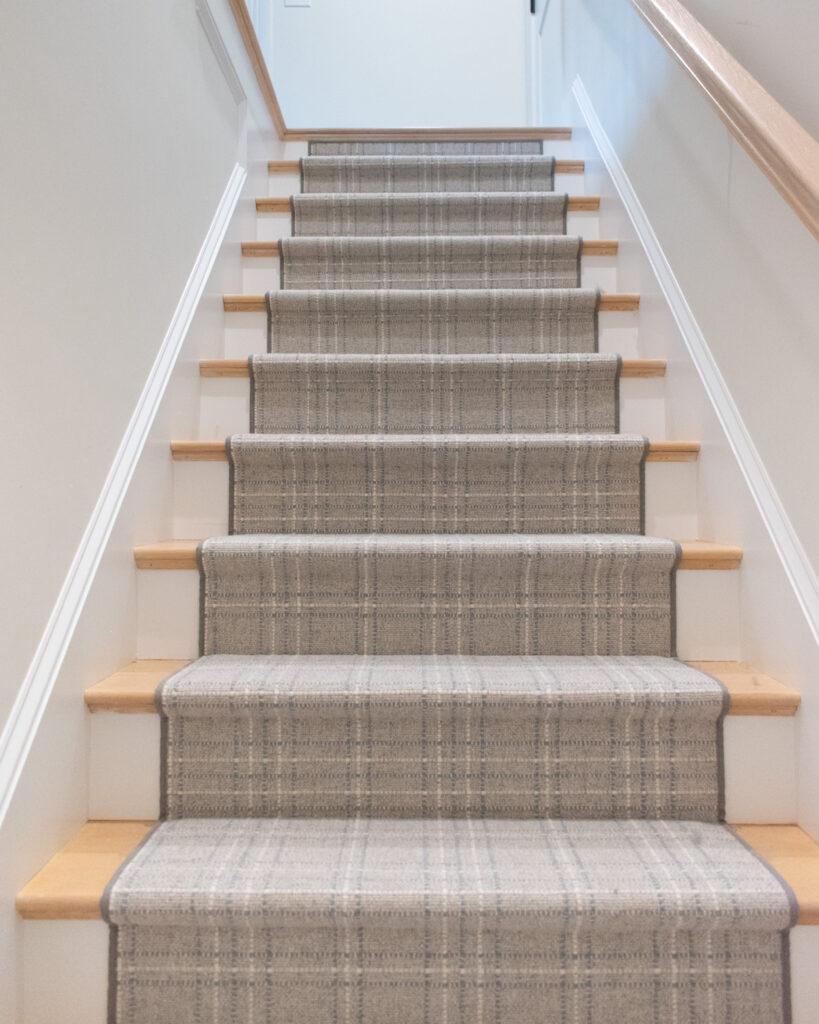 cool neutral stair runner with plaid pattern and Hollywood style install